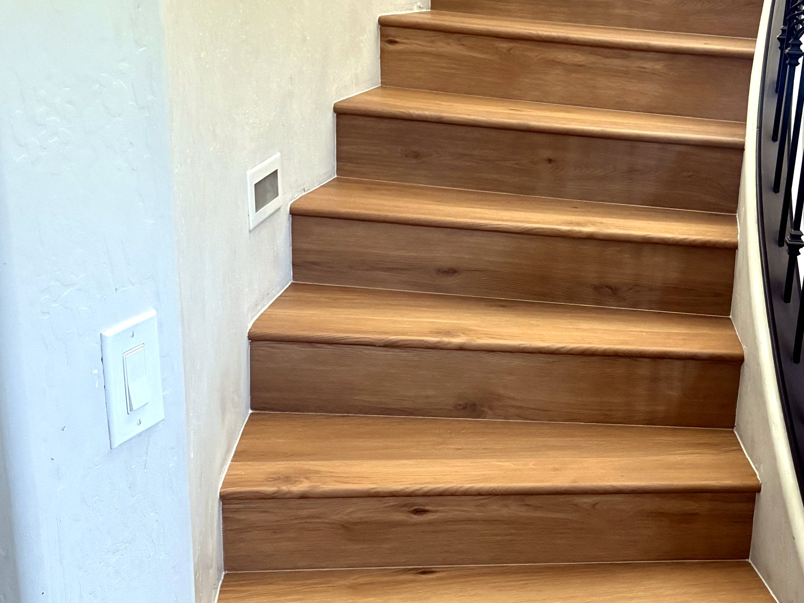 Custom stair treads and risers finished with matching wood-look planks